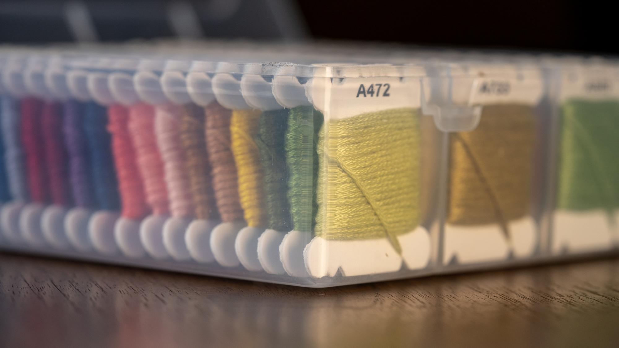 Samples board with embroidered swatches and color threads